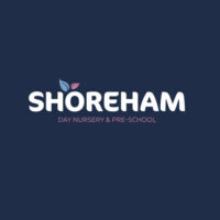 Logo for Shoreham Day Nursery & Pre-School featuring bold white text on a dark blue background, with leaves above the letter "S."
